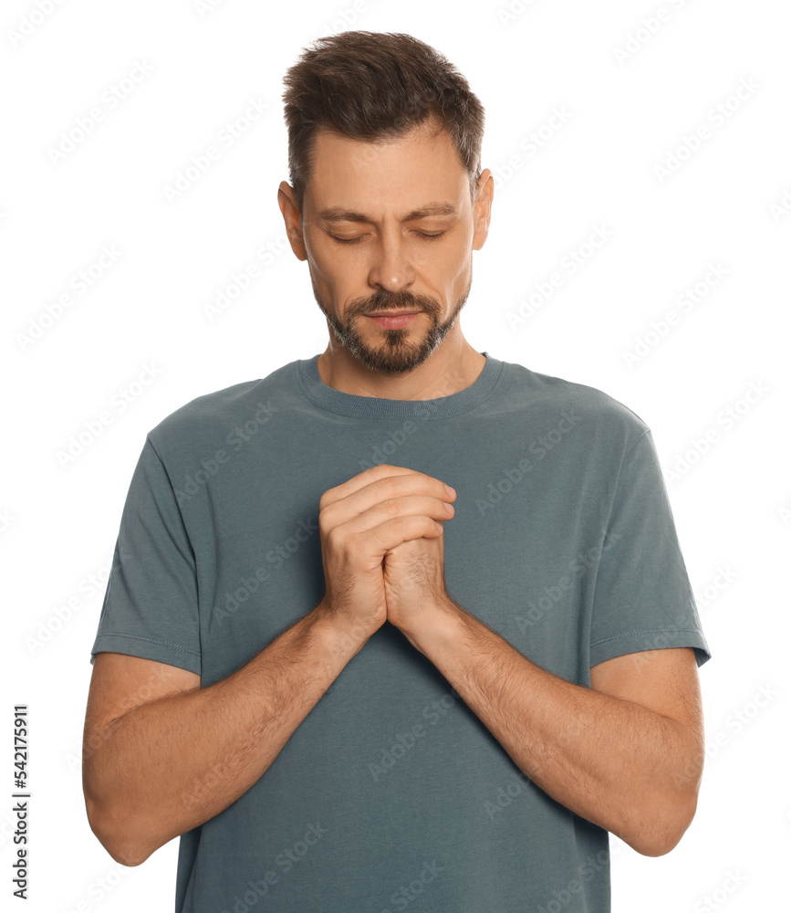 Wall mural Man with clasped hands praying on white background