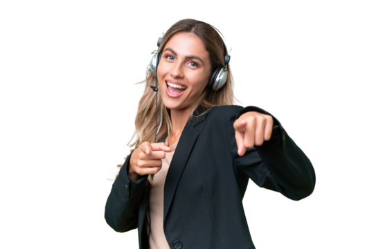 Telemarketer pretty Uruguayan woman working with a headset over isolated background pointing to the front and smiling