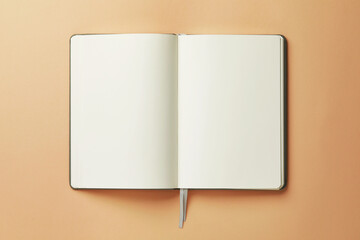 Open notebook on beige background, top view