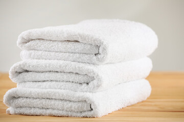Fototapeta na wymiar Stack of folded towels on wooden table