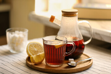 Aromatic tea with lemon and sugar on table