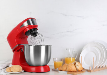Composition with modern red stand mixer and different products on white table