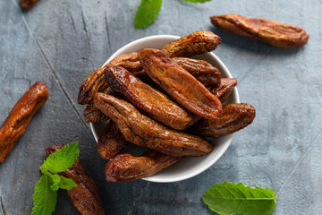Sun dried bananas, healthy vegan vegetarian food snack concept.