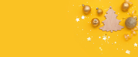 Composition with beautiful Christmas decorations on yellow background with space for text