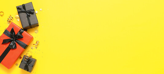 Gift boxes on yellow background with space for text. Black Friday sale