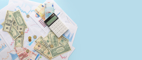 Dollar and euro banknotes with coins, calculator and diagrams on blue background with space for text. Exchange rate concept