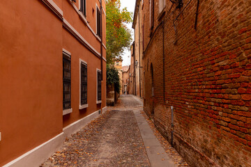 Fototapeta na wymiar Historic streets of Ferrara, Italy. Narrow streets, historic building facades.