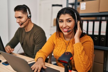 Man and woman ecommerce call center agents working at ecommerce office