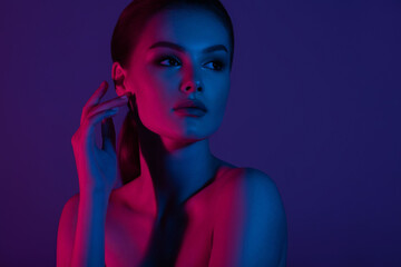 Woman on pink blue neon background. © Mirrorstudio