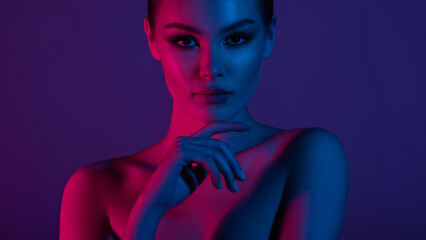 Woman on pink blue neon background.