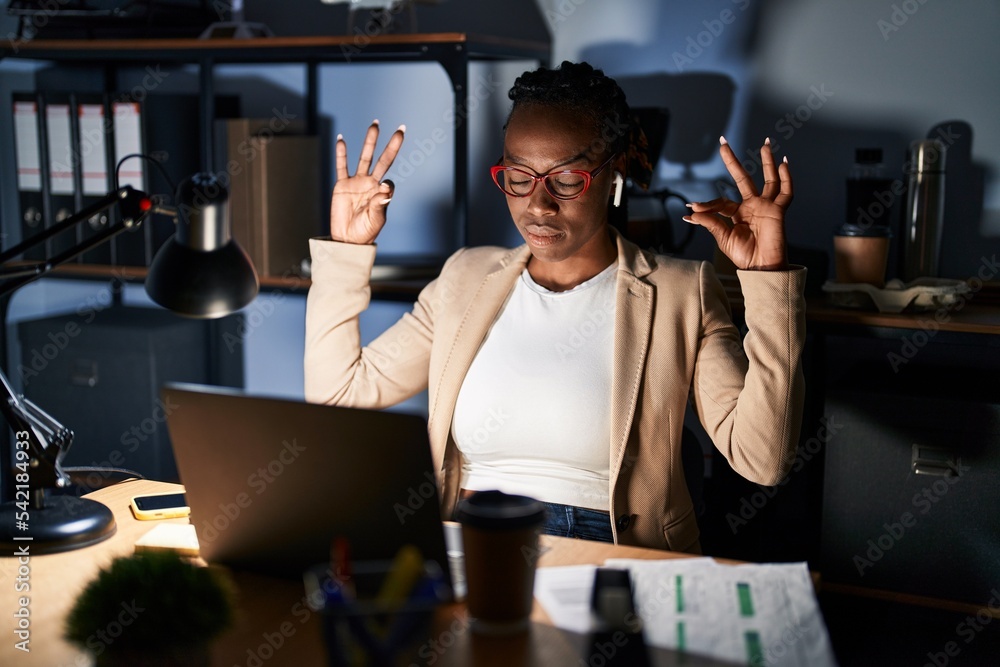 Sticker beautiful black woman working at the office at night relax and smiling with eyes closed doing medita