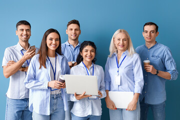 Business colleagues with laptops and cups of coffee on blue background