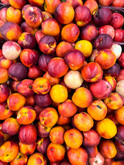 Tasty ripe peaches as background, top view