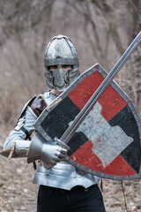 Noble warrior. Portrait of one medeival warrior or knight in armor and helmet with shield and sword...