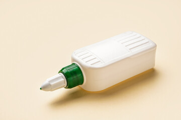 Bottle of glue on color background