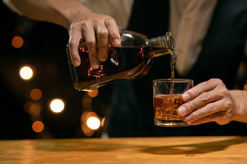 Barman pouring whiskey whiskey glass beautiful night