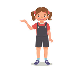 cute little girl showing presenting with hand for copy space 