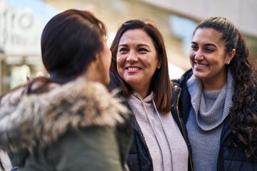 Three woman mother and daughters standing together at street