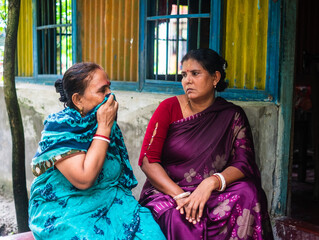 South asian hindu religious women sharing their stories to each other, elderly woman crying in...