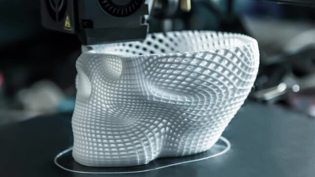 The 3D printer prints white plastic model of skull. modern technology.