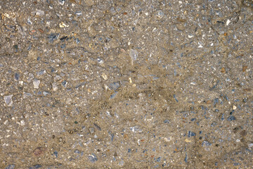 The texture of the asphalt pavement interspersed with stones