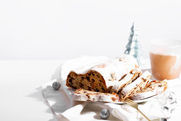 Christmas stollen and spices on white background.