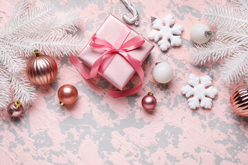 Composition with Christmas gift and decorations on color background