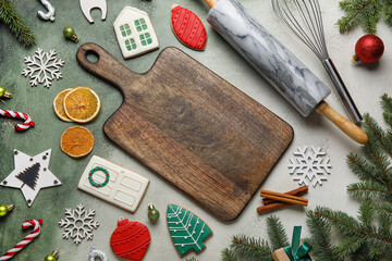 Fototapeta na wymiar Composition with wooden board, Christmas cookies and kitchen utensils on grunge background