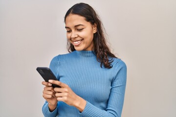 Young african american woman smiling confident using smartphone over isolated white background