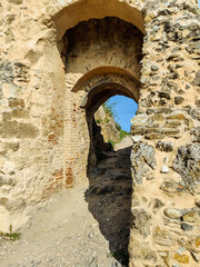 Arched passage in ancient Rupa fortress in Romania. Fortress was built on ruins of former Dacian defensive structure. Selective focus.