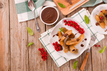 Mini churros with chocolate dipping sauce.