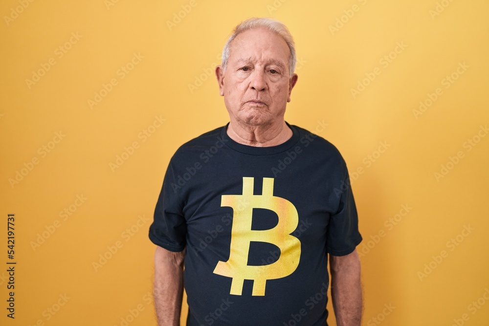 Sticker senior man with grey hair wearing bitcoin t shirt relaxed with serious expression on face. simple an