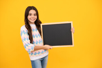 Obraz na płótnie Canvas School sales board. Cheerful teenage girl kid hold blackboard chalkboard with copy space on yellow background.