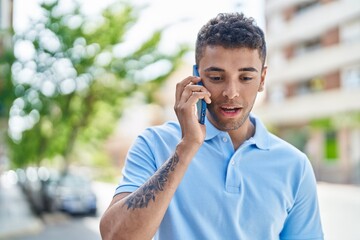 African american man talking on the smartphone at street