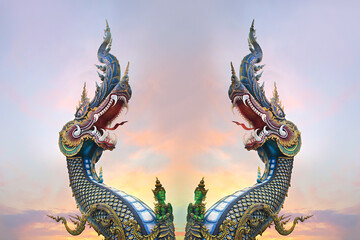 Fototapeta na wymiar Two King of Nagas, Great Naga on sunset sky, sculpture found in the Buddhism temples, Wat Rong Sua Ten, Chiang Rai, Thailand