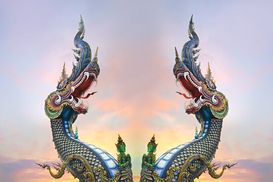Two King of Nagas, Great Naga on sunset sky, sculpture found in the Buddhism temples, Wat Rong Sua Ten, Chiang Rai, Thailand
