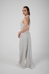 Stunning model posing in a white polka dot set