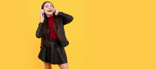 online education. back to school. happy teen girl in headphones full length. music lover. Child portrait with headphones, horizontal poster. Girl listening to music, banner with copy space.