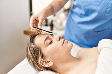 Obraz na płótnie Canvas Woman couple having eyebrows treatment at beauty center