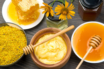 Fresh flower honey of different varieties, pollen and honeycomb with spoons on a wooden background. Organic Vitamin Health Food