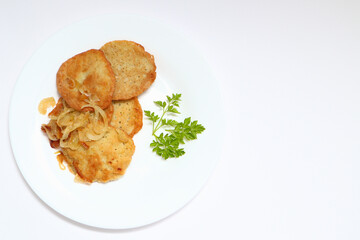 Potato pancakes or latkes or draniki on white plate. Top view. Copy space. Fried potato pancakes