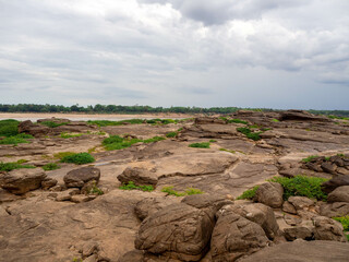 The rock field or rock shore with the green grass called Han Hong is famous in the middle of the Mekong river during the dry season.