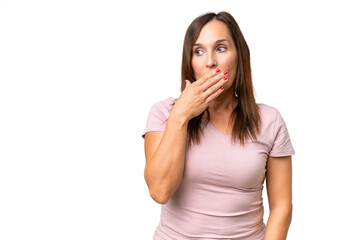 Middle-aged caucasian woman over isolated background doing surprise gesture while looking to the side