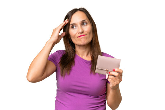 Middle-aged caucasian woman holding a wallet over isolated background having doubts and with confuse face expression