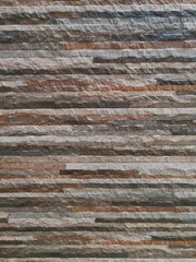 Rock stone brick tile wall aged texture detailed pattern background.
