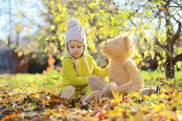 Children Having Fun And Balancing On Tree In Fall Woodland