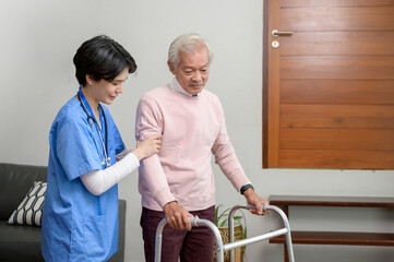 Asian nurse taking care of an elderly man with walker at senior healthcare center.