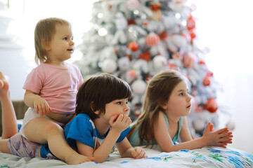 Obraz premium Merry bright christmas. Lovely baby enjoy christmas. Childhood memories. Santa girl little child celebrate christmas at home. Family holiday. Girl cute child cheerful mood play near christmas tree.