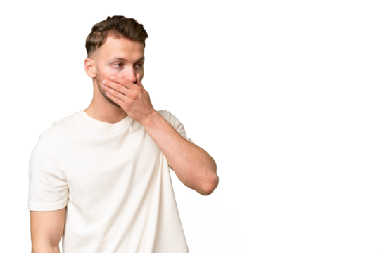 Young blonde caucasian man over isolated background doing surprise gesture while looking to the side