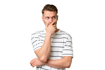 Young blonde caucasian man over isolated background having doubts and with confuse face expression